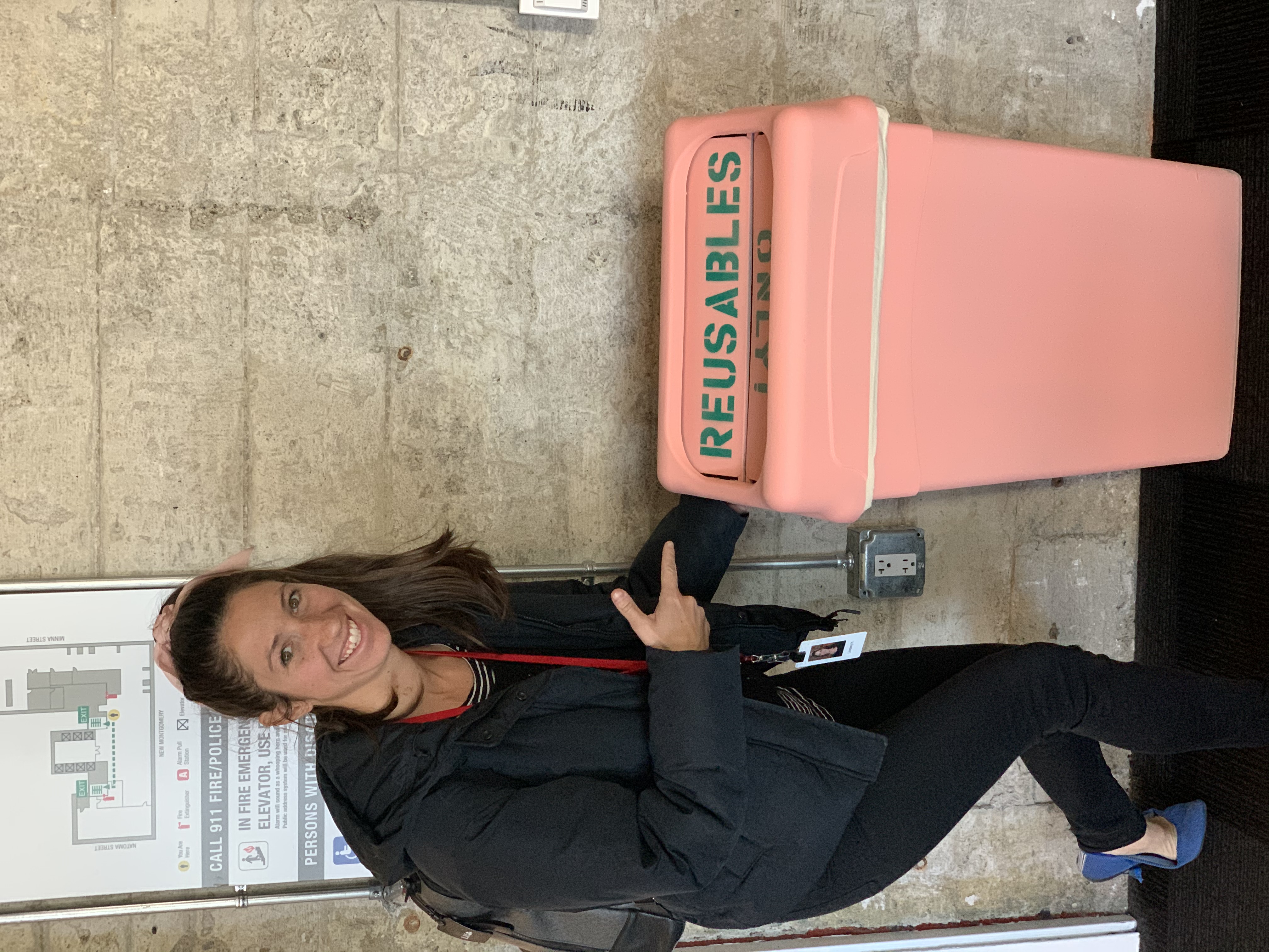Lindsey standing next to container return bin