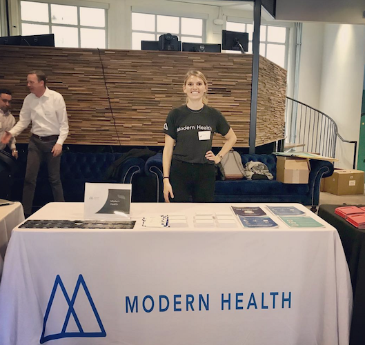 Alyson at a conference booth